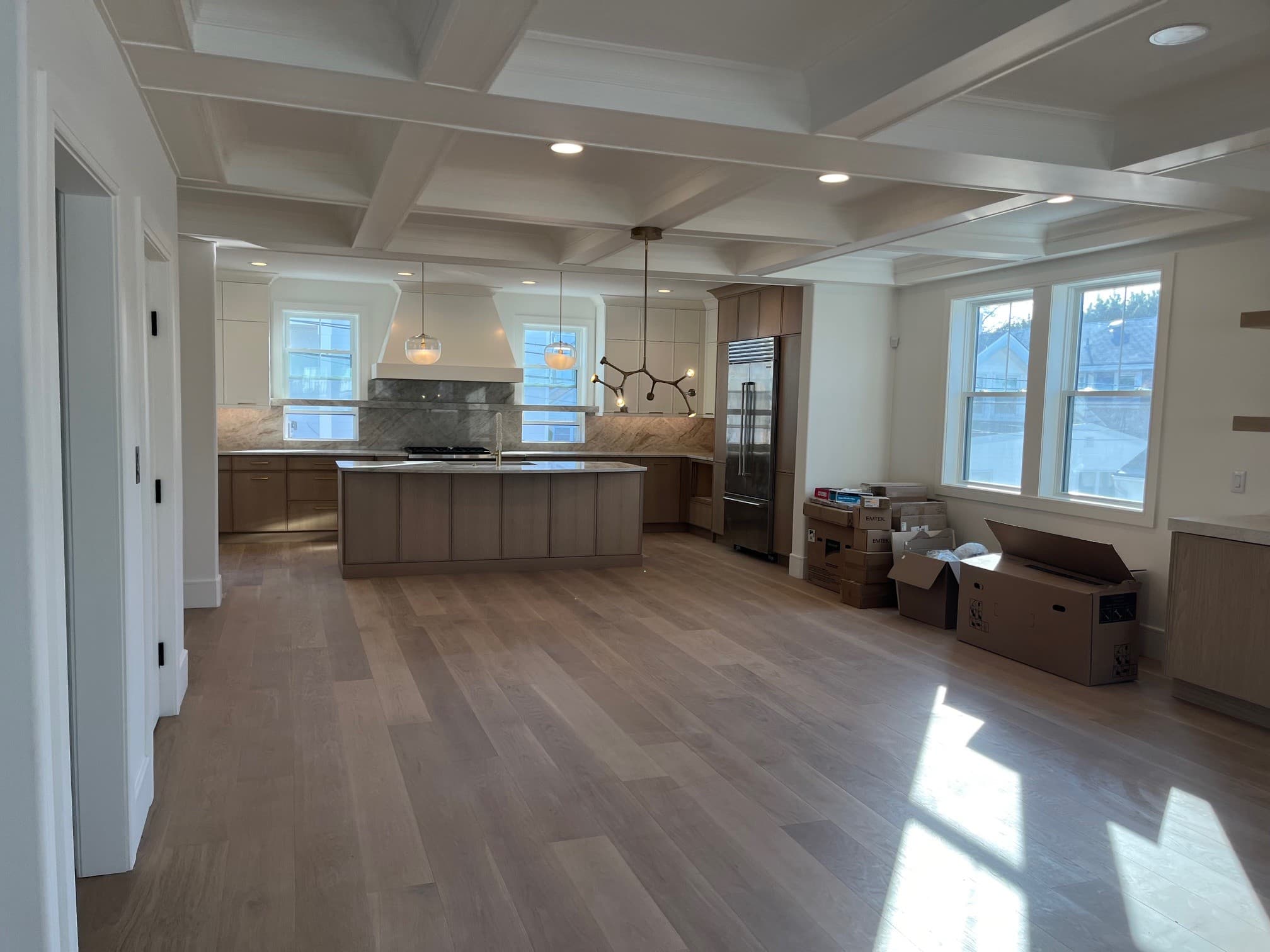 Open custom kitchen showing coordinated structure and finish work